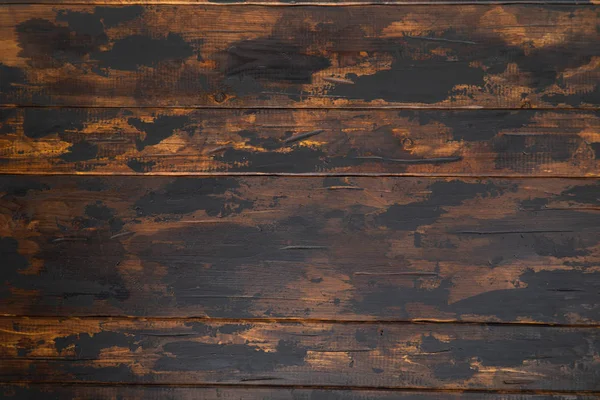 Old wooden surface background, scuffed boards with black paint stains. — Stock Photo, Image