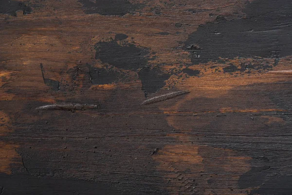 Old wooden surface background, scuffed boards with black paint stains. — Stock Photo, Image