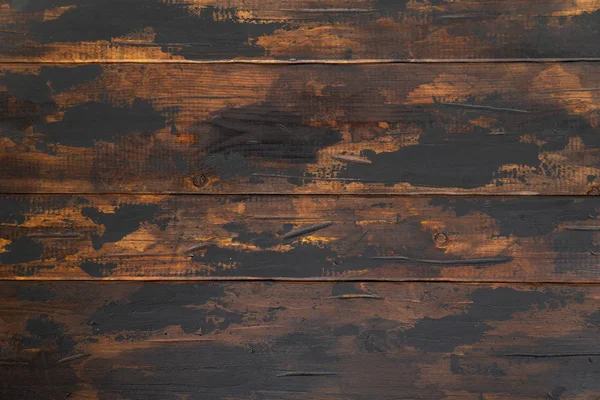 Old wooden surface background, scuffed boards with black paint stains. — Stock Photo, Image