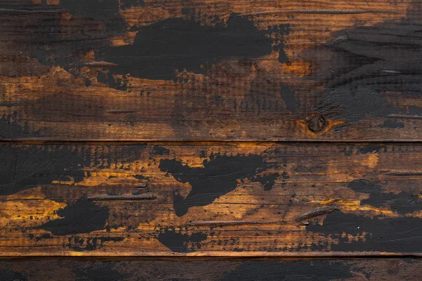 Old wooden surface background, scuffed boards with black paint stains. — Stock Photo, Image