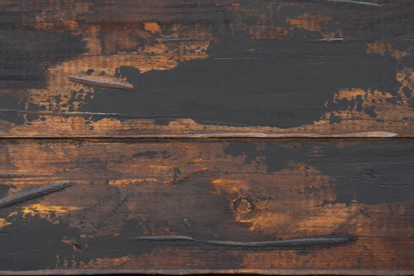 Old wooden surface background, scuffed boards with black paint stains. — Stock Photo, Image