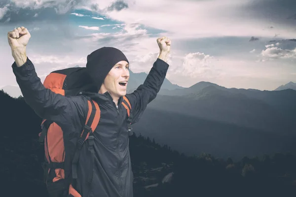 Giovane escursionista gridando in cima con le mani alzate, vista laterale . — Foto Stock