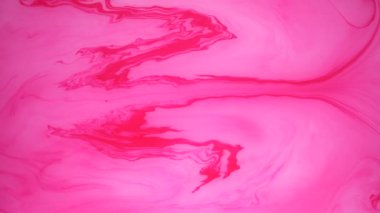 Sudaki pembe ve beyaz mürekkep lekeleri. Soyut arka plan görüntüleri.