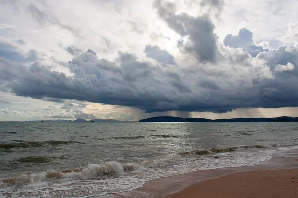 Storm clouds over the island scenery with sea view, clouds, and waves.