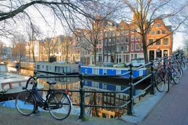Renkli miras binaları ve yüzen Brouwersgracht kanalı Amsterdam, Hollanda yansımasıdır. Güneş doğarken Papiermolensluis Köprüsü'nden alınan resim.