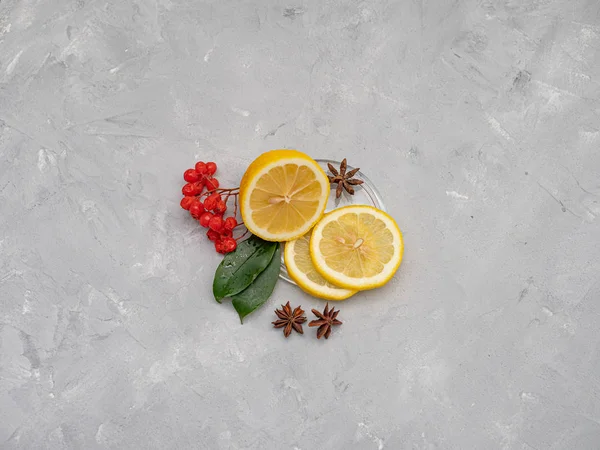 Lemon cut with lemon slices on a transparent plate, decorated wi