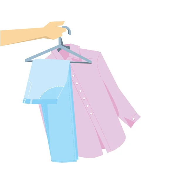 Hand holding pants and shirt on hangers. — Stock Vector