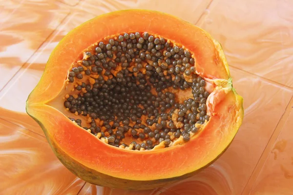 Orange open papaya with black seeds. Papaya close-up. Fruits of Asia, healthy food, natural fruits.