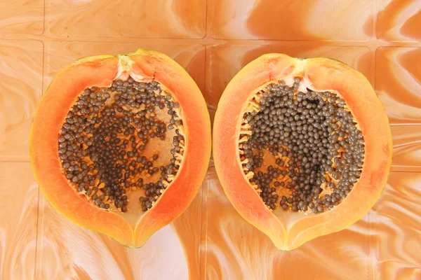 Orange open papaya with black seeds. Papaya close-up. Fruits of Asia, healthy food, natural fruits.