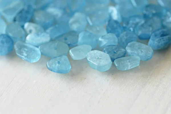 Aquamarine is blue. Natural stone is blue aquamarine. The backgr