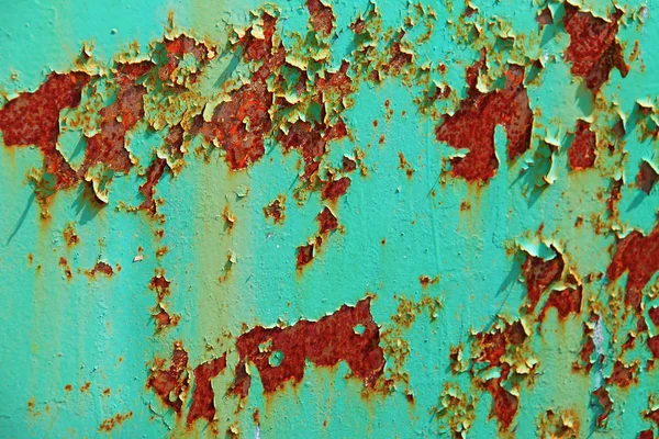 Rusty background. Terracotta rust against a turquoise shabby pai