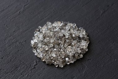Siyah bir arka plan üzerinde dağınık elmas. Ham elmas ve minin