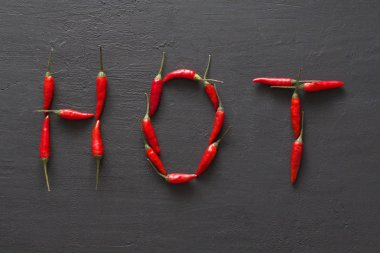 Siyah karanlık arka planda kelime sıcak kırmızı sıcak Chili Peppers