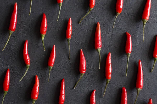 Red Hot Chili Peppers On Black Dark Background on Black Table. A