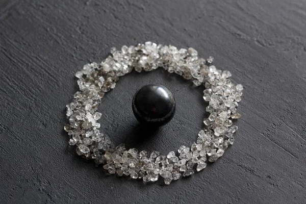 Scattered diamonds on a black background. Raw diamonds and minin