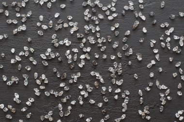 Scattered diamonds on a black background. Raw diamonds and minin clipart