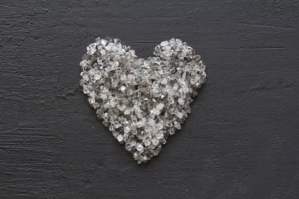 Heart of stones, love. Scattered diamonds on black background. R