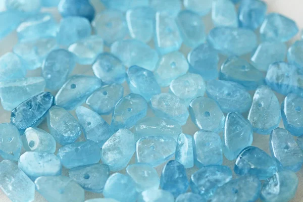 Aquamarine is blue. Natural stone is blue aquamarine. The backgr