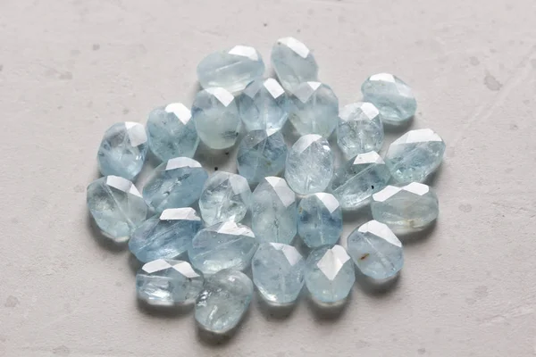Aquamarine stone. Natural stone and aquamarine crystals on a whi