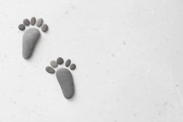 Footprints made of stones. Happy feet. Stone arranged like footp