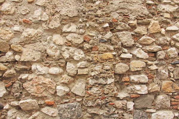 Sfondo di pietre marroni, beige e grigie. Il vecchio muro di Ston — Foto Stock