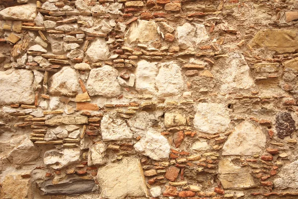 Background of brown, beige and gray stones. The old wall of ston — Stock Photo, Image