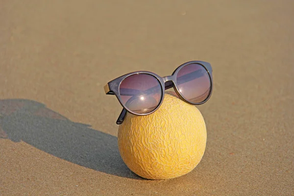 Yellow beautiful melon in glasses, on the beach and on the sea,