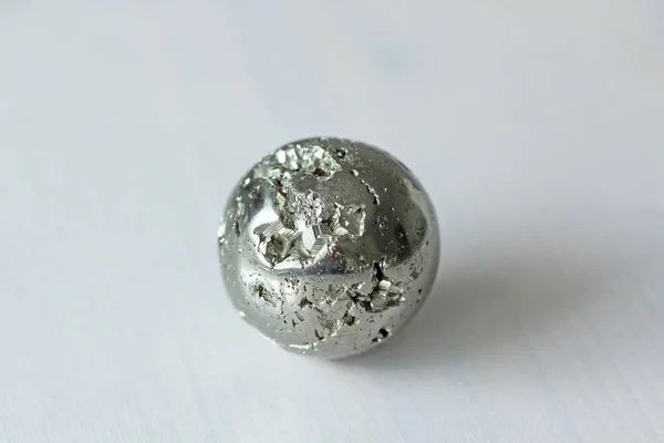 Beautiful iron ball from natural pyrite. On a white background.