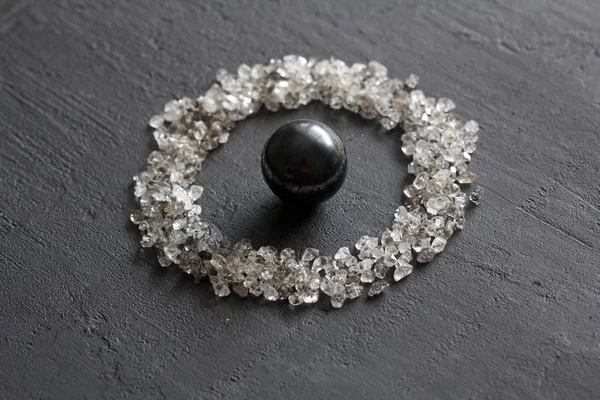Scattered diamonds on a black background. Raw diamonds and minin