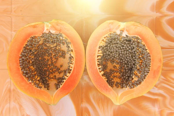 Orange open papaya with black seeds. Papaya close-up. Fruits of