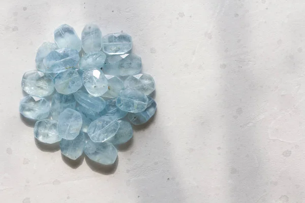 Aquamarine stone. Natural stone and aquamarine crystals on a whi