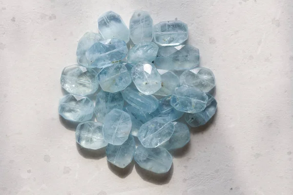 Aquamarine stone. Natural stone and aquamarine crystals on a whi