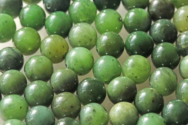 Natural green jade nephrite mineral stones beads. Green and gras