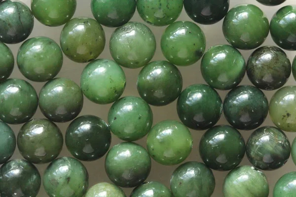 Natural green jade nephrite mineral stones beads. Green and gras