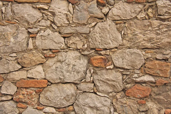 Background of brown, beige and gray stones. The old wall of ston — Stock Photo, Image