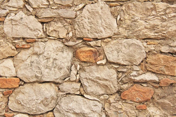 Background of brown, beige and gray stones. The old wall of ston — Stock Photo, Image