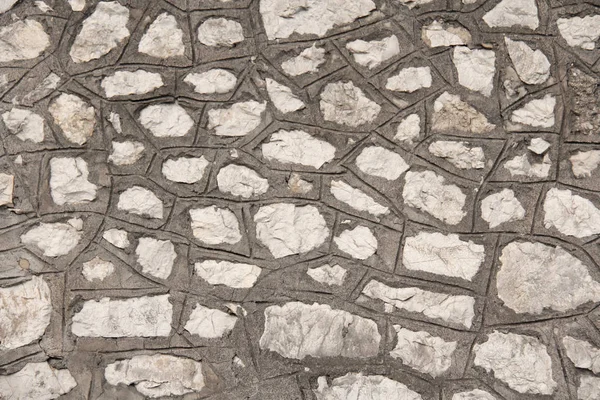 Una pared de las Grandes Piedras Antiguas. Fondo de piedra gris y beige — Foto de Stock
