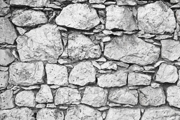 Eine Mauer aus den großen alten Steinen. grauer und beiger Steinhintergrund — Stockfoto