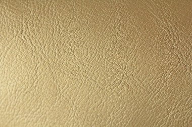 Altın veya bronz doğal deri arka plan. Parlak sarı yaprak gol