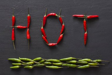 Siyah karanlık arka planda kelime sıcak kırmızı sıcak Chili Peppers