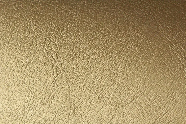 Gold or Bronze Natural Leather Background. Shiny yellow leaf gol