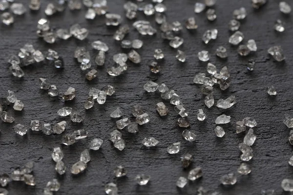 Siyah bir arka plan üzerinde dağınık elmas. Ham elmas ve minin