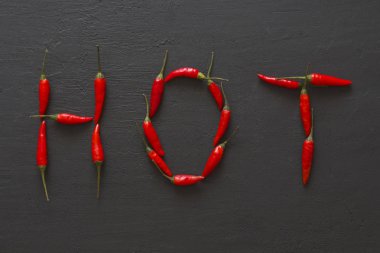 Siyah karanlık arka planda kelime sıcak kırmızı sıcak Chili Peppers
