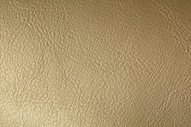 Altın veya bronz doğal deri arka plan. Parlak sarı yaprak gol