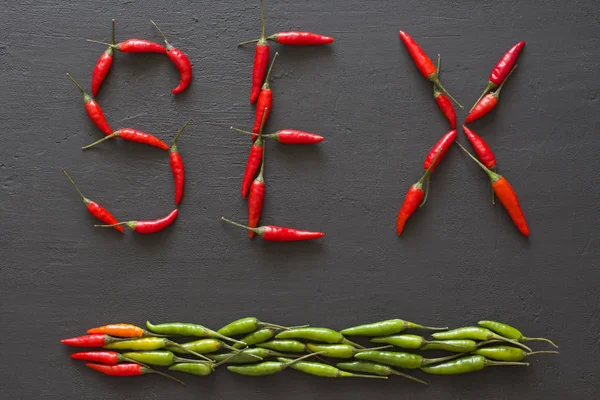 Word Sex Red Hot Chili Peppers On Black Background on Black Tabl