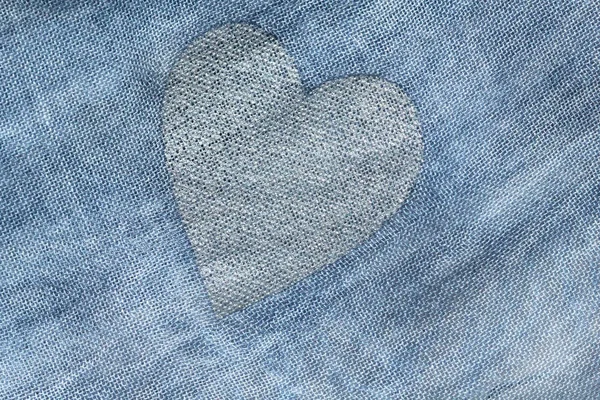 Silver heart on a blue background of cotton fabric. Romantic pas — Stock Photo, Image