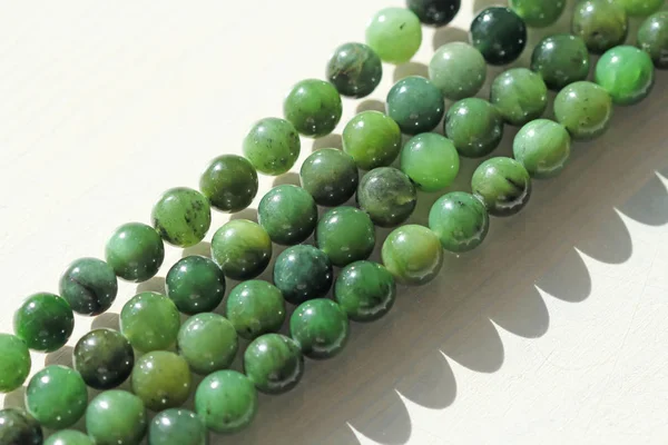 Natural green jade nephrite mineral stones beads. Green and gras