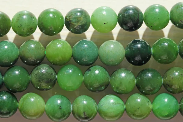 Natural green jade nephrite mineral stones beads. Green and gras