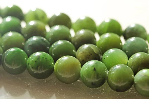 Natural green jade nephrite mineral stones beads. Green and gras — Stock Photo, Image