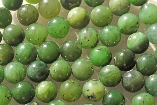 Natural green jade nephrite mineral stones beads. Green and gras